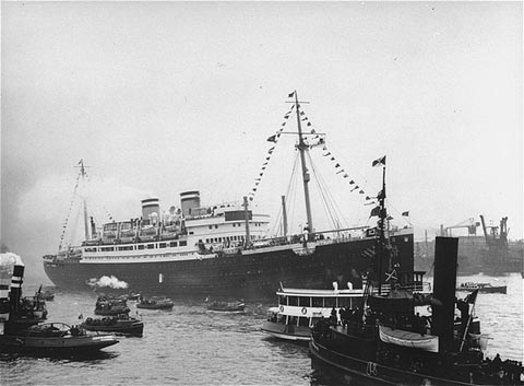 Black and white photograph of a passenger ship surrounded by smaller boats.